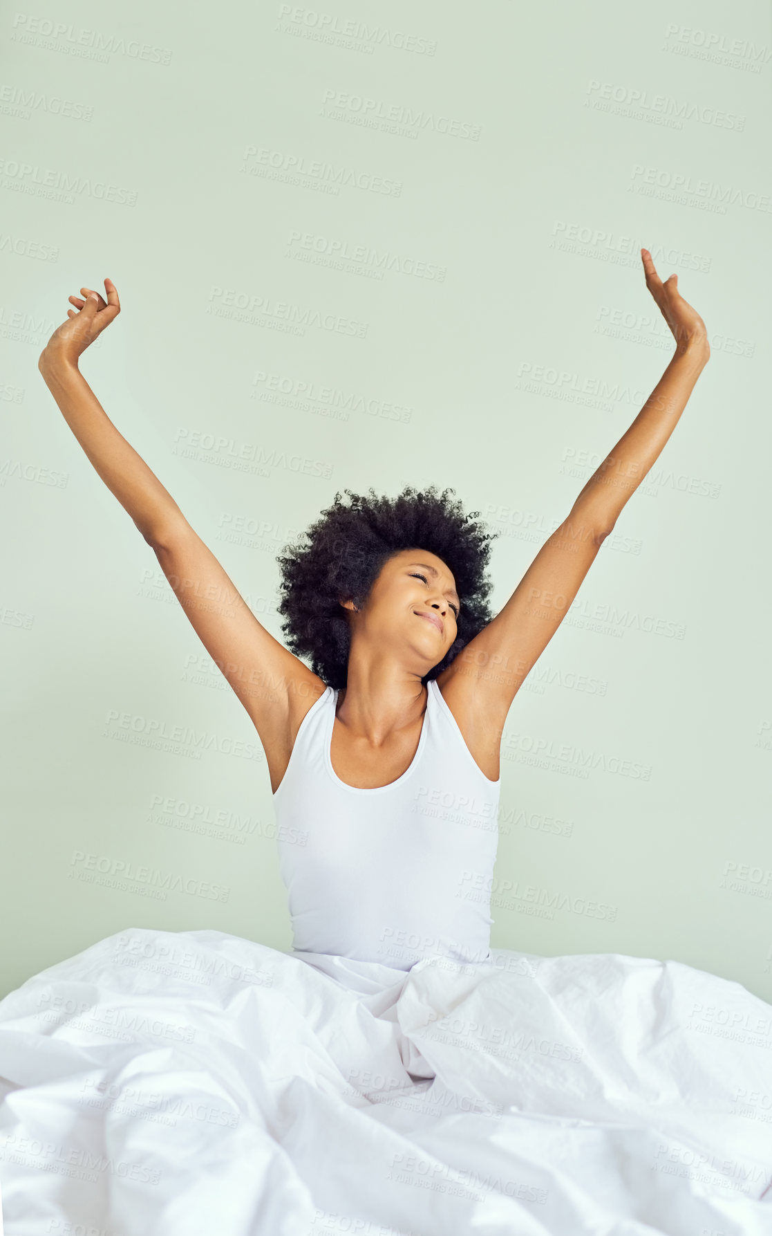 Buy stock photo Cropped shot of an attractive young woman waking up and stretching in bed at home