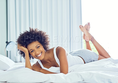 Buy stock photo Shot of an attractive young woman chilling on her bed at home
