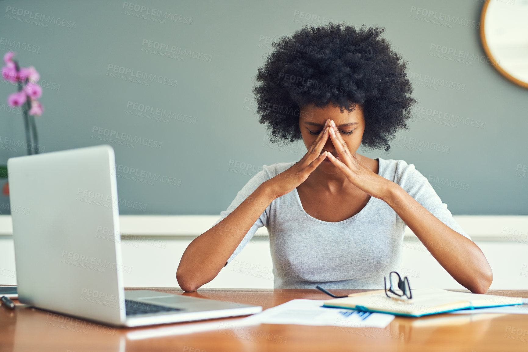 Buy stock photo Cropped shot of a young businesswoman looking stressed while working at home