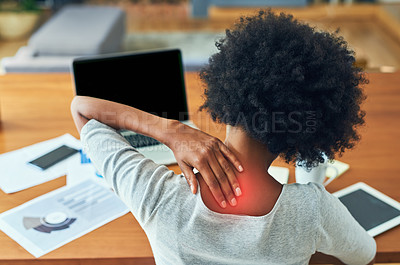 Buy stock photo Rearview shot of an unrecognizable businesswoman suffering from neck pain while working at home