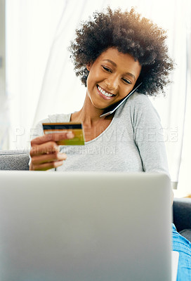Buy stock photo Cropped shot of an attractive young woman using her laptop to shop online at home over the weekend
