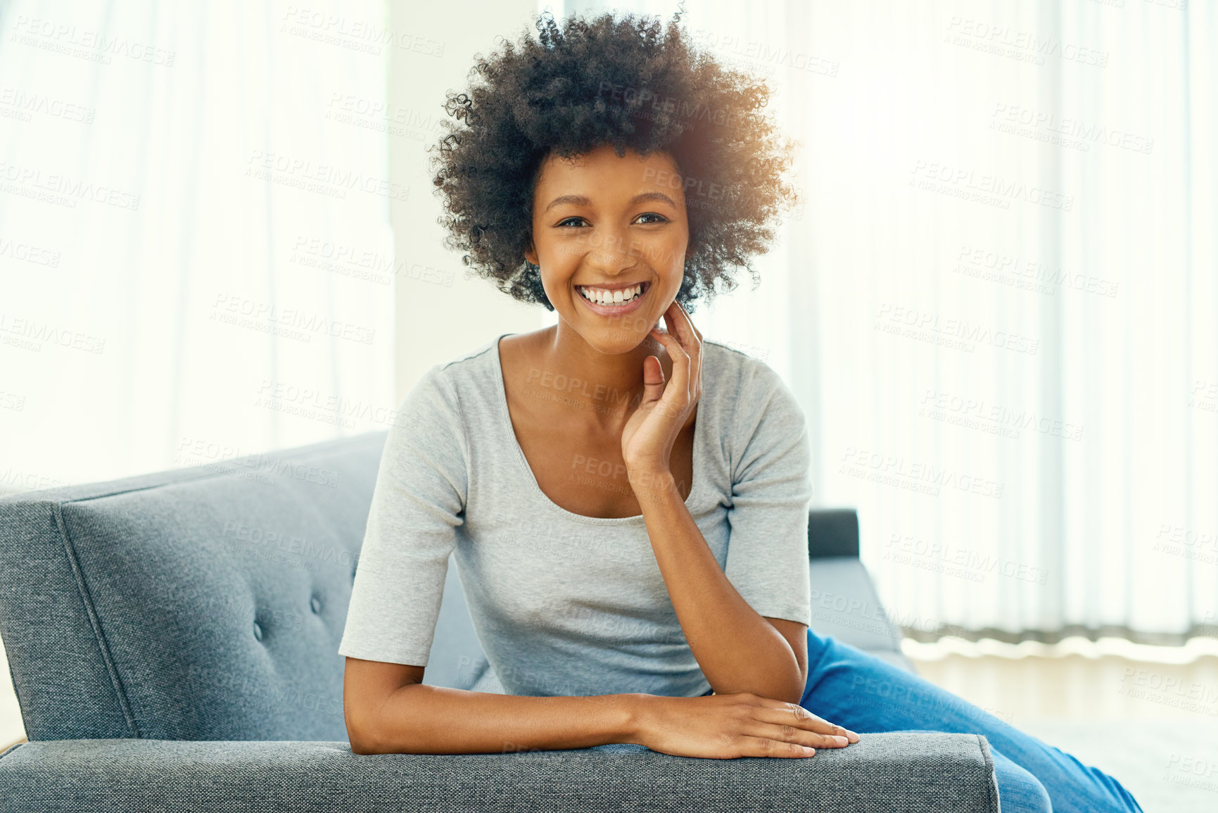 Buy stock photo Cropped portrait of an attractive young woman chilling at home over the weekend