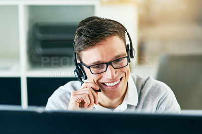 Buy stock photo Shot of a young call center agent working in an office