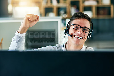Buy stock photo Portrait of a young call centre agent cheering while working in an office