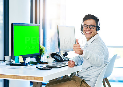 Buy stock photo Portrait of a young call center agent showing thumbs up while working in an office