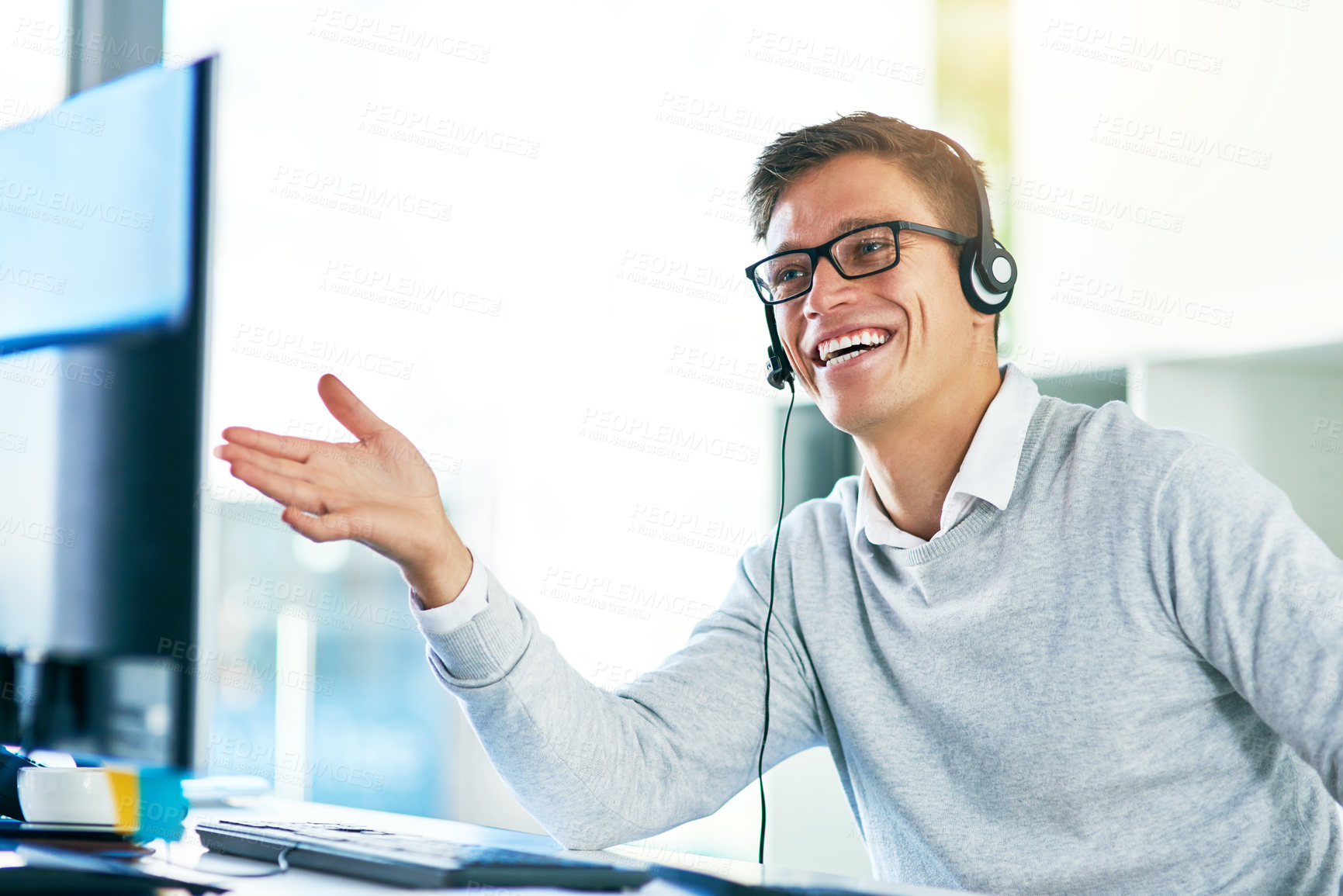 Buy stock photo Shot of a young call center agent working in an office