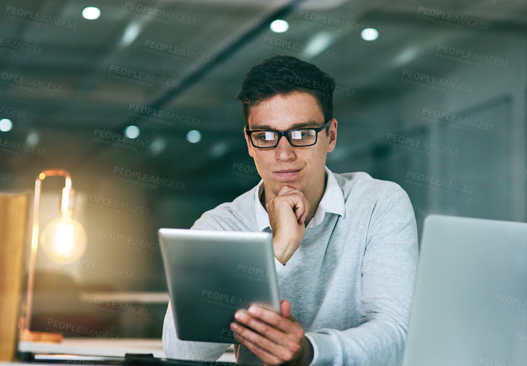 Buy stock photo Employee, thinking and man with tablet, night and thoughts with planning for project ideas. Person, agent or consultant with tech for email, decision or choice for review, feedback or problem solving