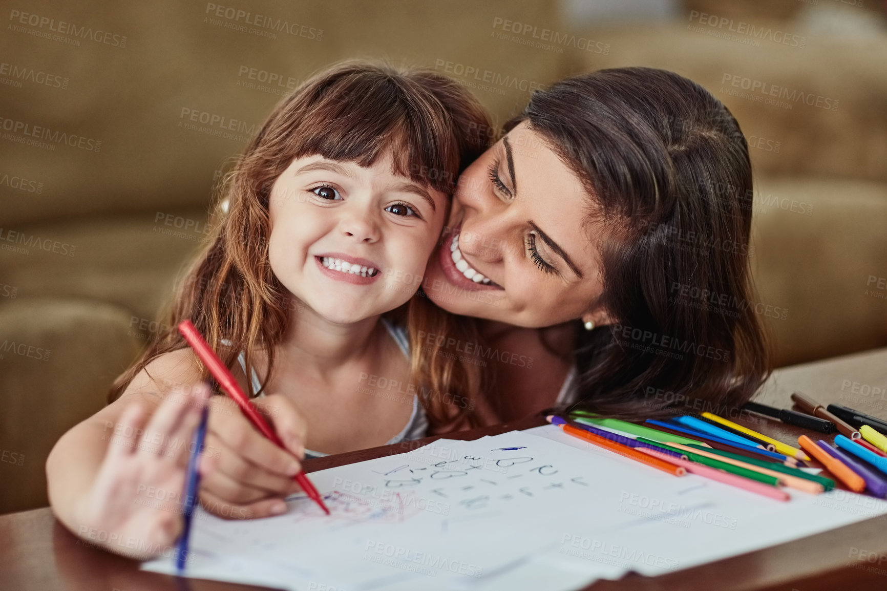 Buy stock photo Portrait of a young woman drawing together with her young daughter at home