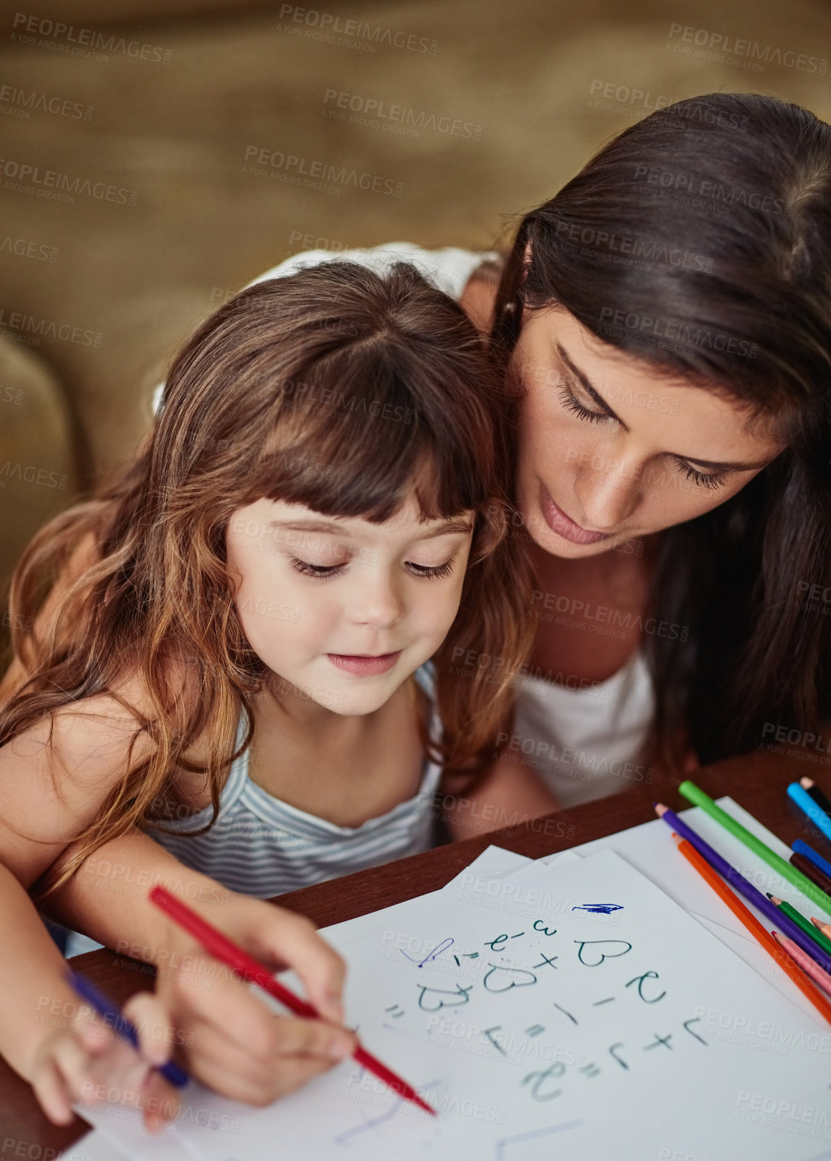 Buy stock photo Shot of a young woman drawing together with her young daughter at home