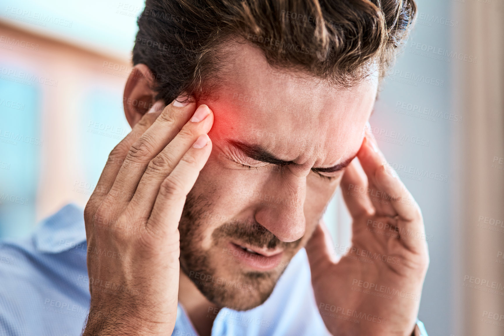 Buy stock photo Shot of a uncomfortable looking man holding his head in discomfort due to pain at home during the day