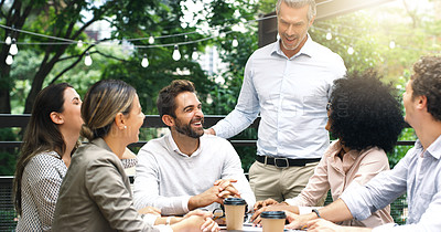 Buy stock photo Shot of a group of businesspeople having a meeting at a cafe