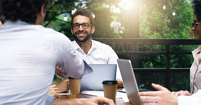 Buy stock photo Shot of businessmen shaking hands during a meeting at a cafe