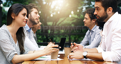 Buy stock photo Shot of a group of businesspeople having a meeting at a cafe