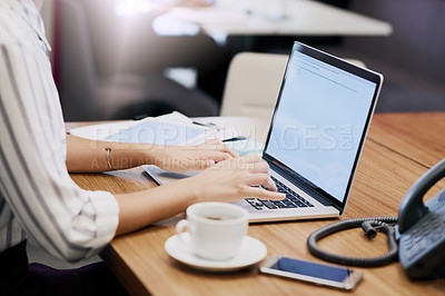 Buy stock photo Cropped shot of an unrecognizable young businesswoman working in her office