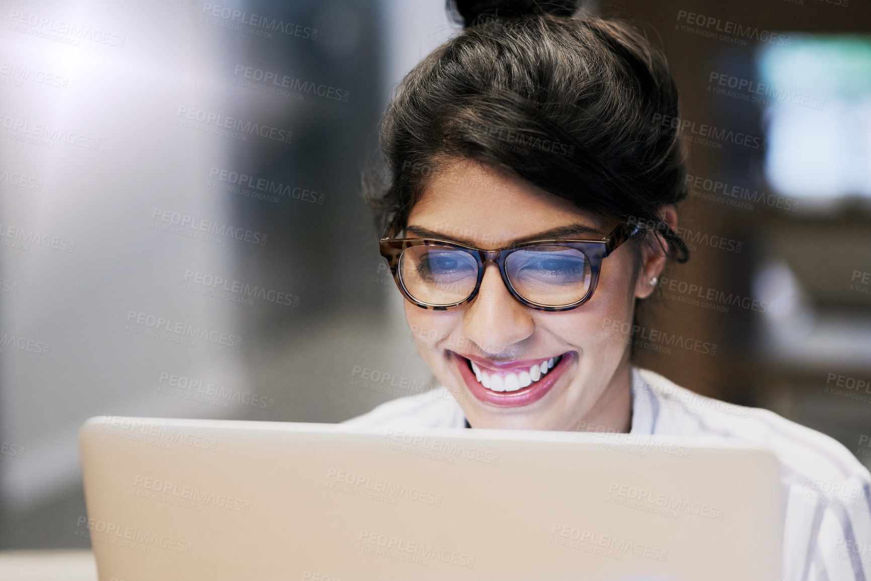 Buy stock photo Shot of a confident young businesswoman working on a laptop in an office