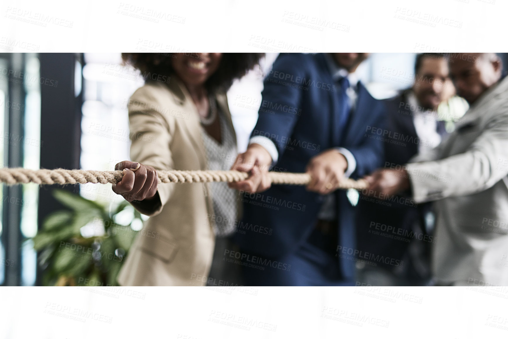 Buy stock photo Closeup shot of a group of unrecognizable businesspeople pulling together on a rope in an office