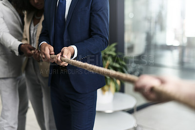Buy stock photo Closeup shot of a group of unrecognizable businesspeople pulling together on a rope in an office