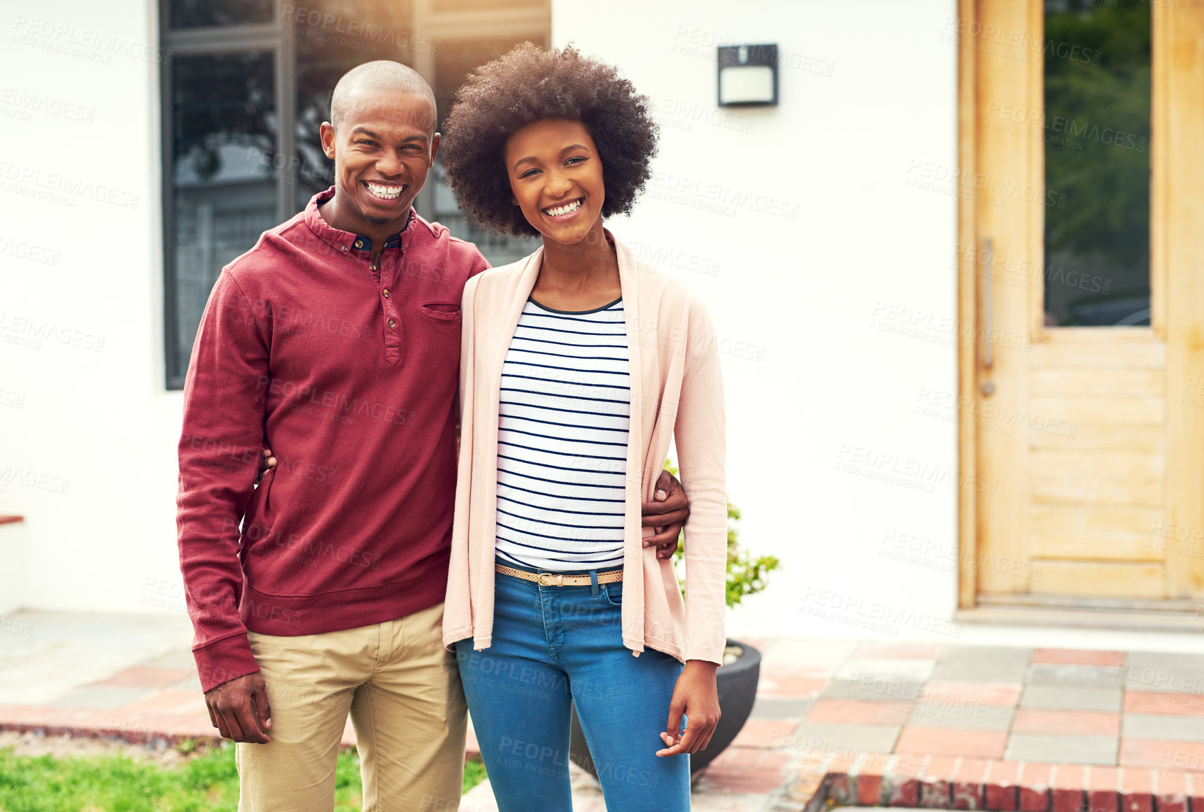 Buy stock photo Portrait of a young couple standing outside their house