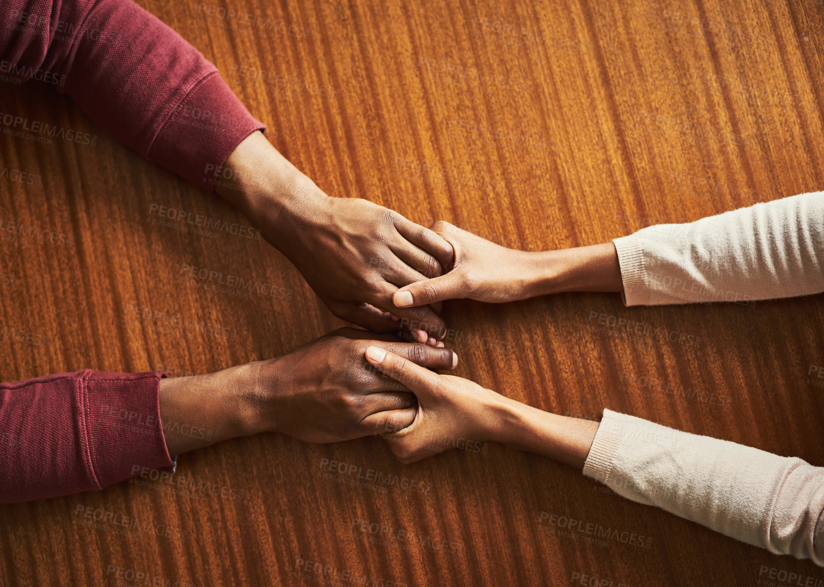 Buy stock photo People, holding hands and above for support in home for care, connection and empathy for mental health. Couple, comfort and partner for help with kindness, bonding and solidarity for grief on table