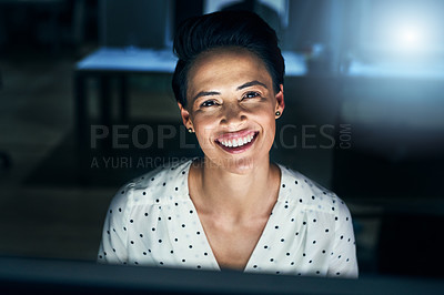 Buy stock photo Portrait of a cheerful young female programmer working on a computer in the office at work during the night