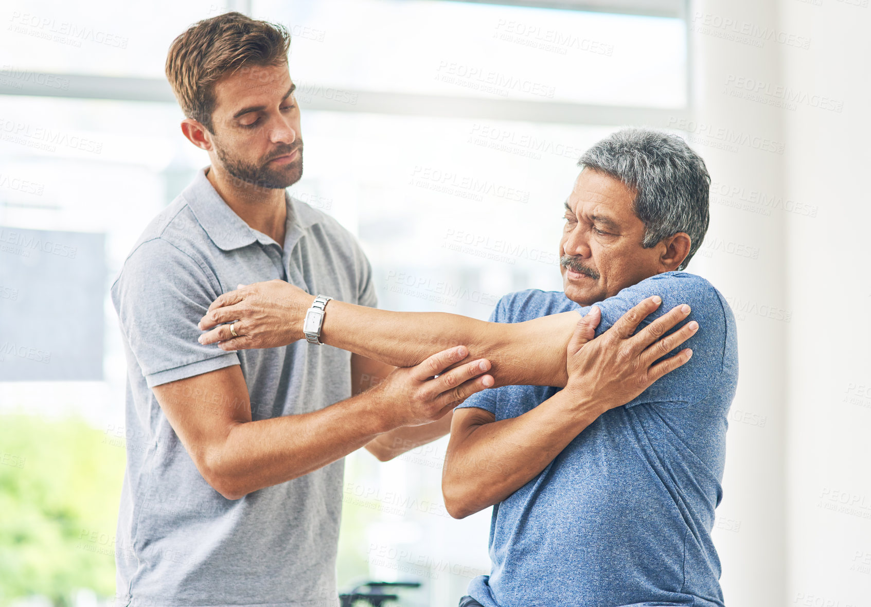 Buy stock photo Physiotherapist, senior man and stretching for support, elderly care and wellness for health or fitness. Pensioner, male person and medic for chiropractic, rehabilitation clinic or retirement home