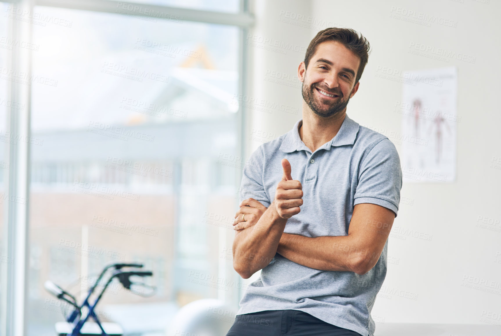 Buy stock photo Cropped portrait of a male physiotherapist giving you the thumbs up in his office