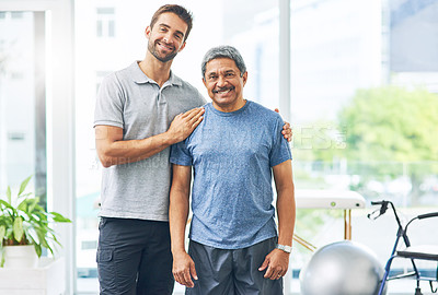 Buy stock photo Cropped portrait of a young male physiotherapist assisting a senior patient in recovery