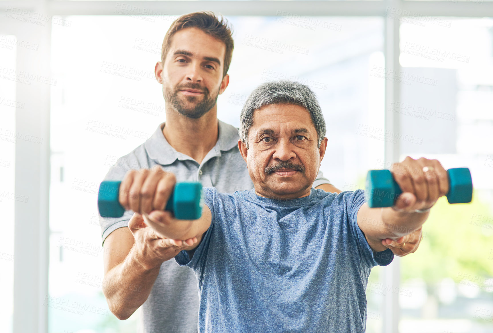 Buy stock photo Elderly man, workout and dumbbell with physiotherapist for rehabilitation, wellness and muscle fitness. Senior person, portrait and hand weight for management of pain, arthritis and healthy exercise 