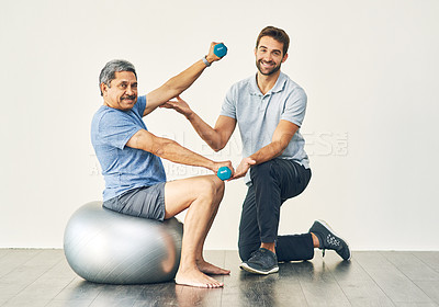 Buy stock photo Full length portrait of a young male physiotherapist assisting a senior patient in recovery