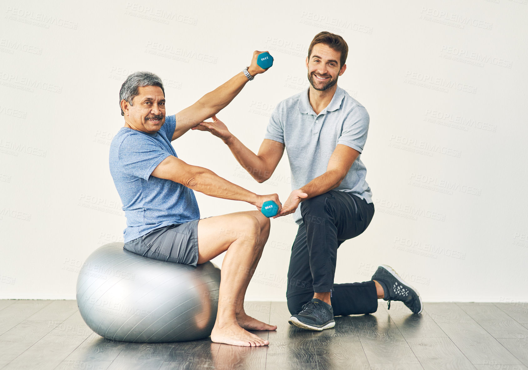 Buy stock photo Senior patient, workout and dumbbell with physiotherapist for rehabilitation, wellness and recovery. Elderly man, exercise and hand weight for management of pain, fitness and muscle health of anatomy