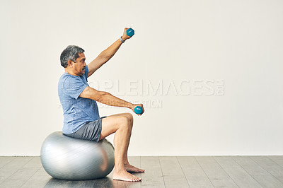 Buy stock photo Full length shot of a senior male going through his physiotherapy routine
