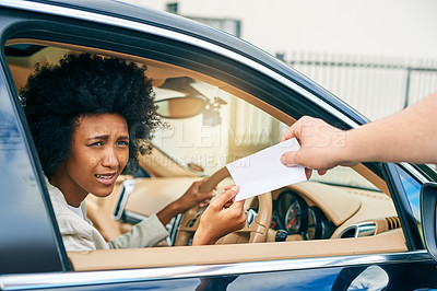 Buy stock photo Shot of a unhappy young businesswoman driving a car while receiving a parking ticket outside during the day