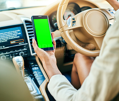 Buy stock photo Closeup of an unrecognizable businesswoman holding her cellphone while driving in a car on her way to work during the day