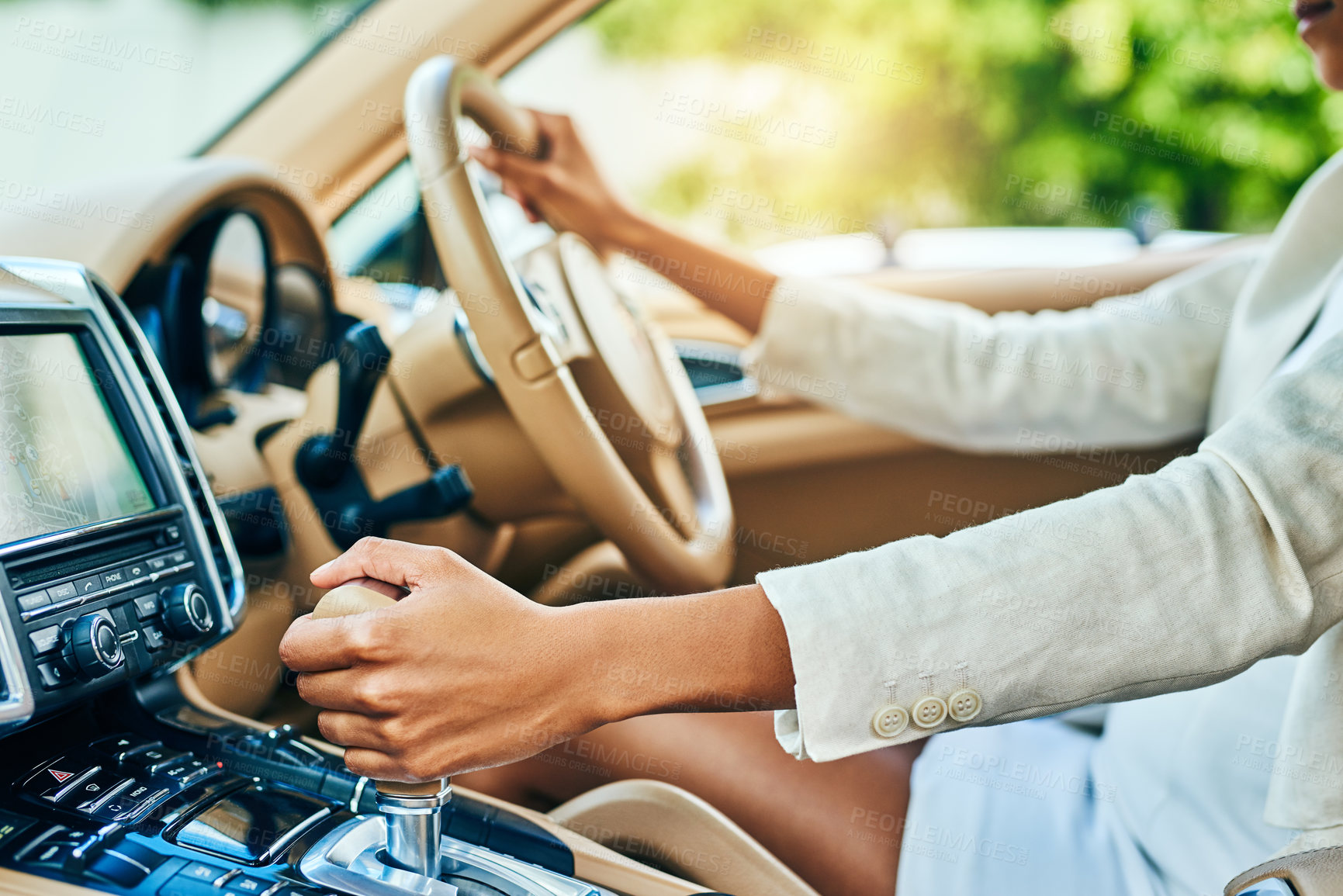 Buy stock photo Shot of an unrecognizable businesswoman driving in a car and changing gears while going to work during the day