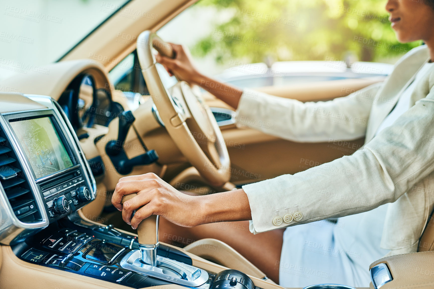 Buy stock photo Shot of an unrecognizable businesswoman driving in a car and changing gears while going to work during the day