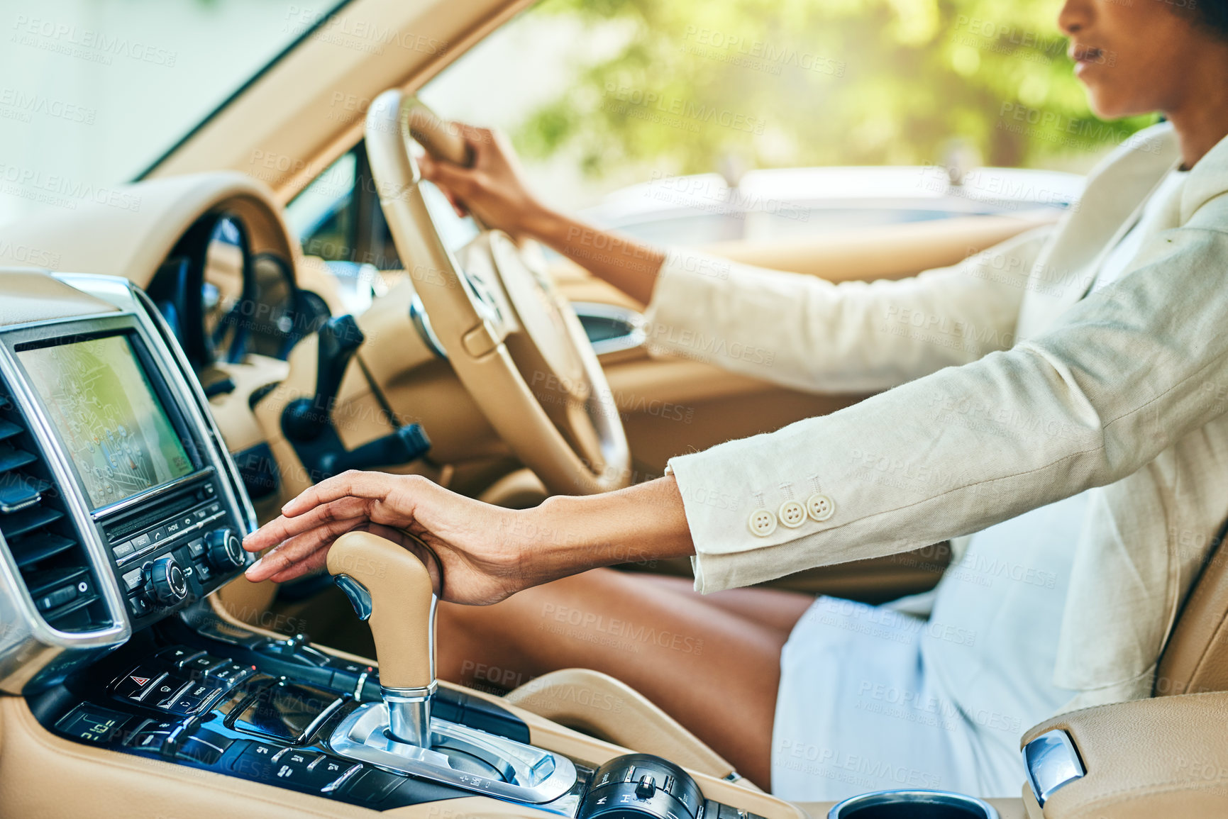 Buy stock photo Shot of an unrecognizable businesswoman driving in a car and changing gears while going to work during the day