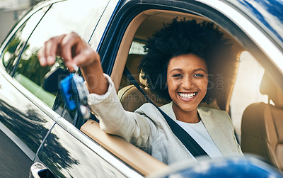 Buy stock photo Portrait of a cheerful young woman driving in her car to work while holding a set of keys during the day