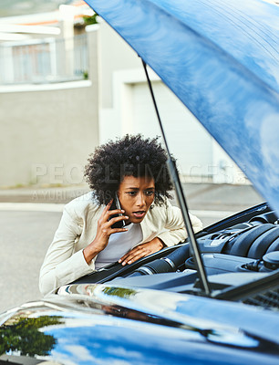 Buy stock photo Shot of a stressed out young businesswoman talking on her phone while trying to see what's wrong with her car outside during the day