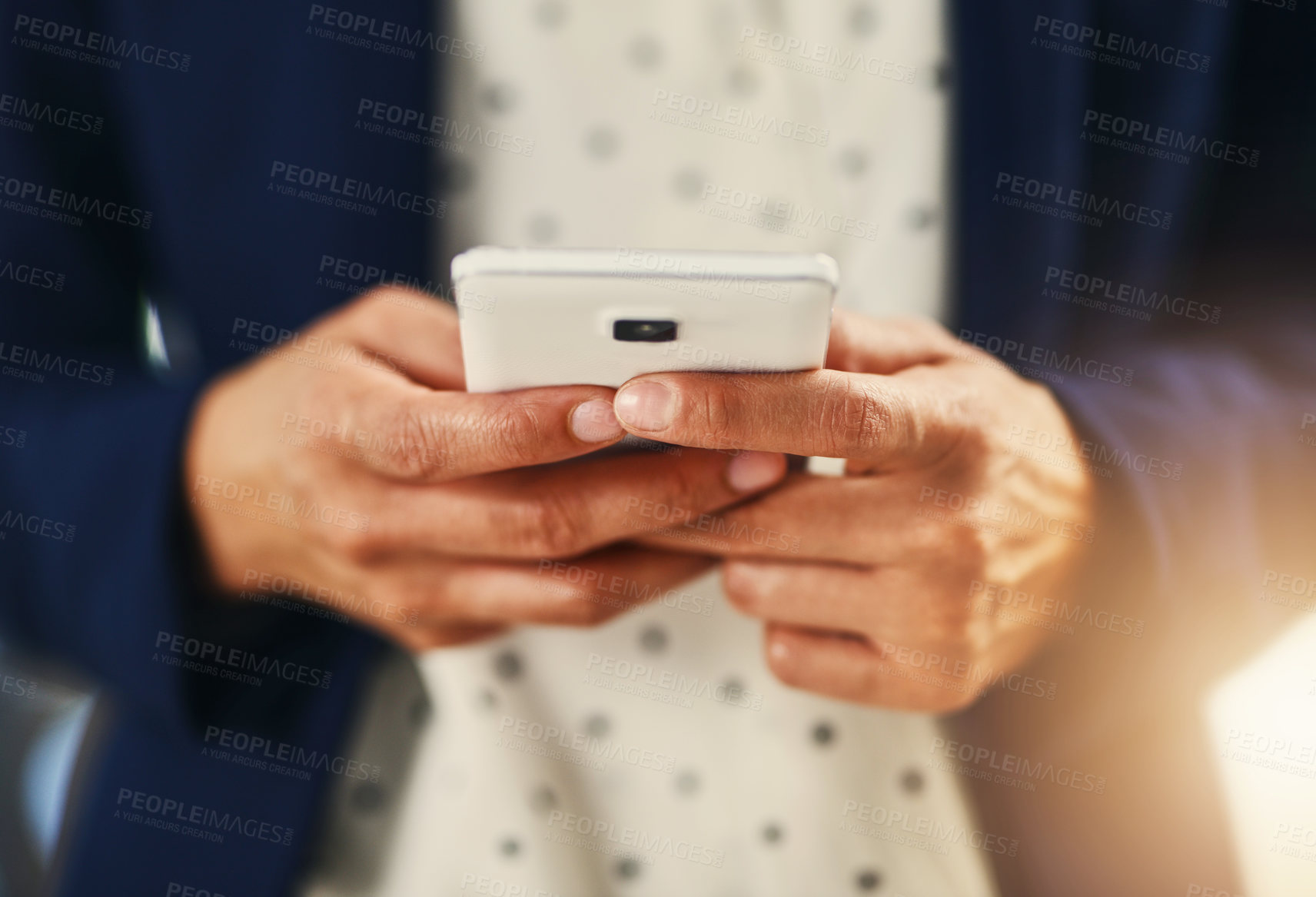 Buy stock photo Closeup shot of an unrecognizable businesswoman using a cellphone in an office