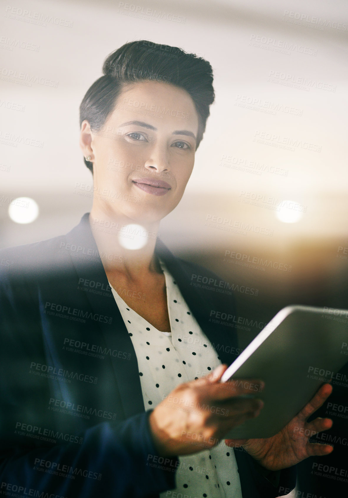 Buy stock photo Portrait of a young businesswoman working late on a digital tablet in an office