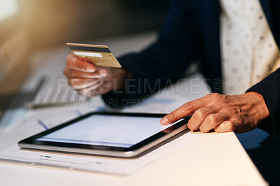 Buy stock photo Closeup shot of an unrecognizable businesswoman making an online purchase using a credit card and digital tablet at the office