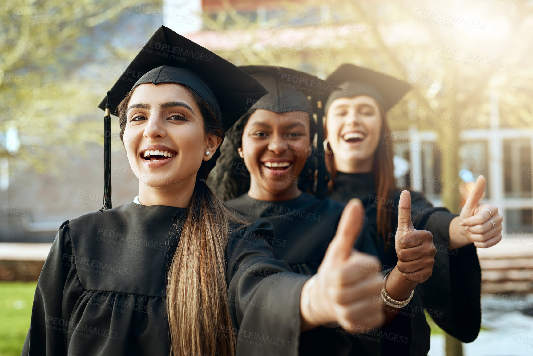 Buy stock photo Portrait of a group of young women showing thumbs up on graduation day