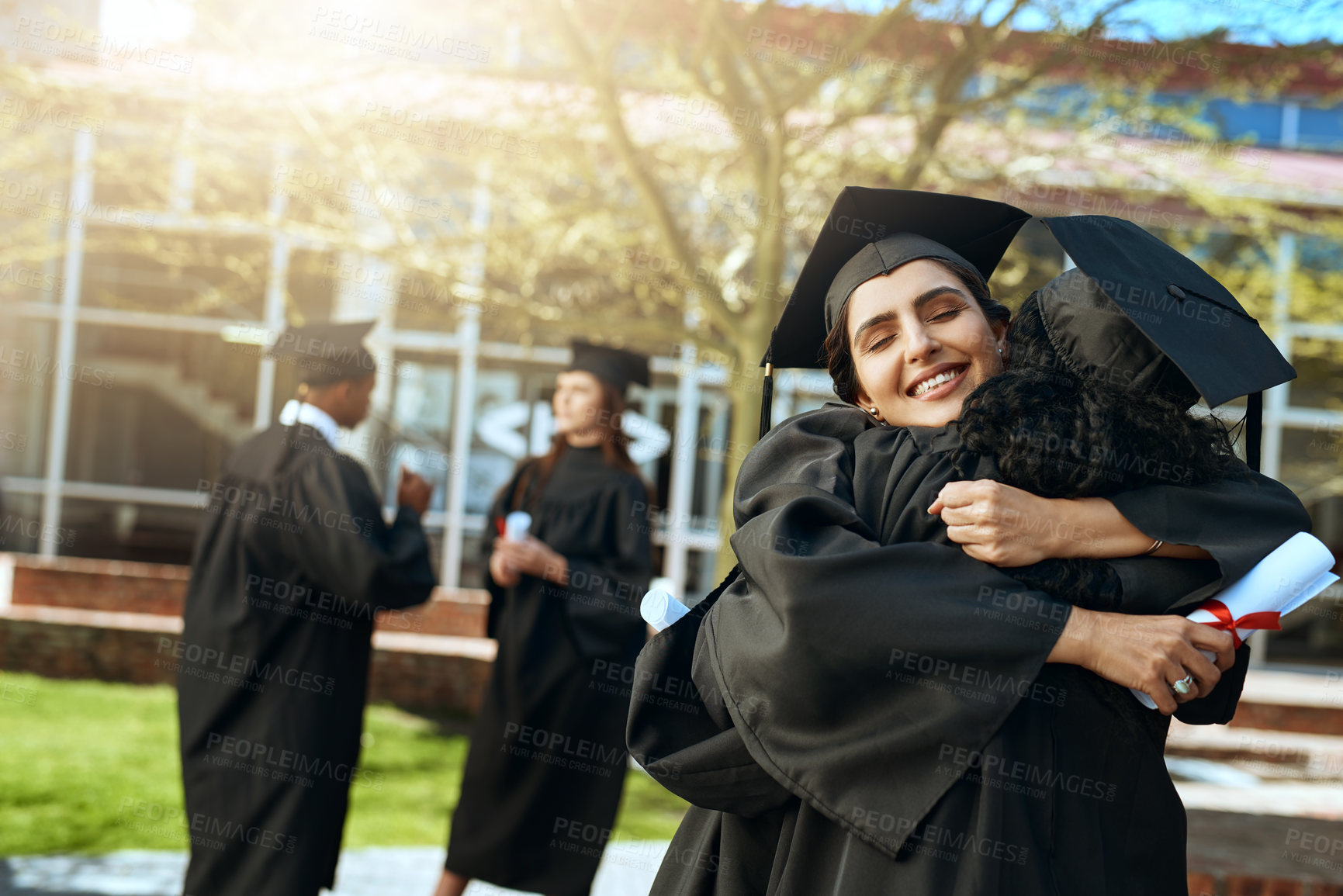 Buy stock photo Students, women and happy on hug for graduation on campus with celebration and success. People, college and university classmate or friends with smile or excited for qualification competition