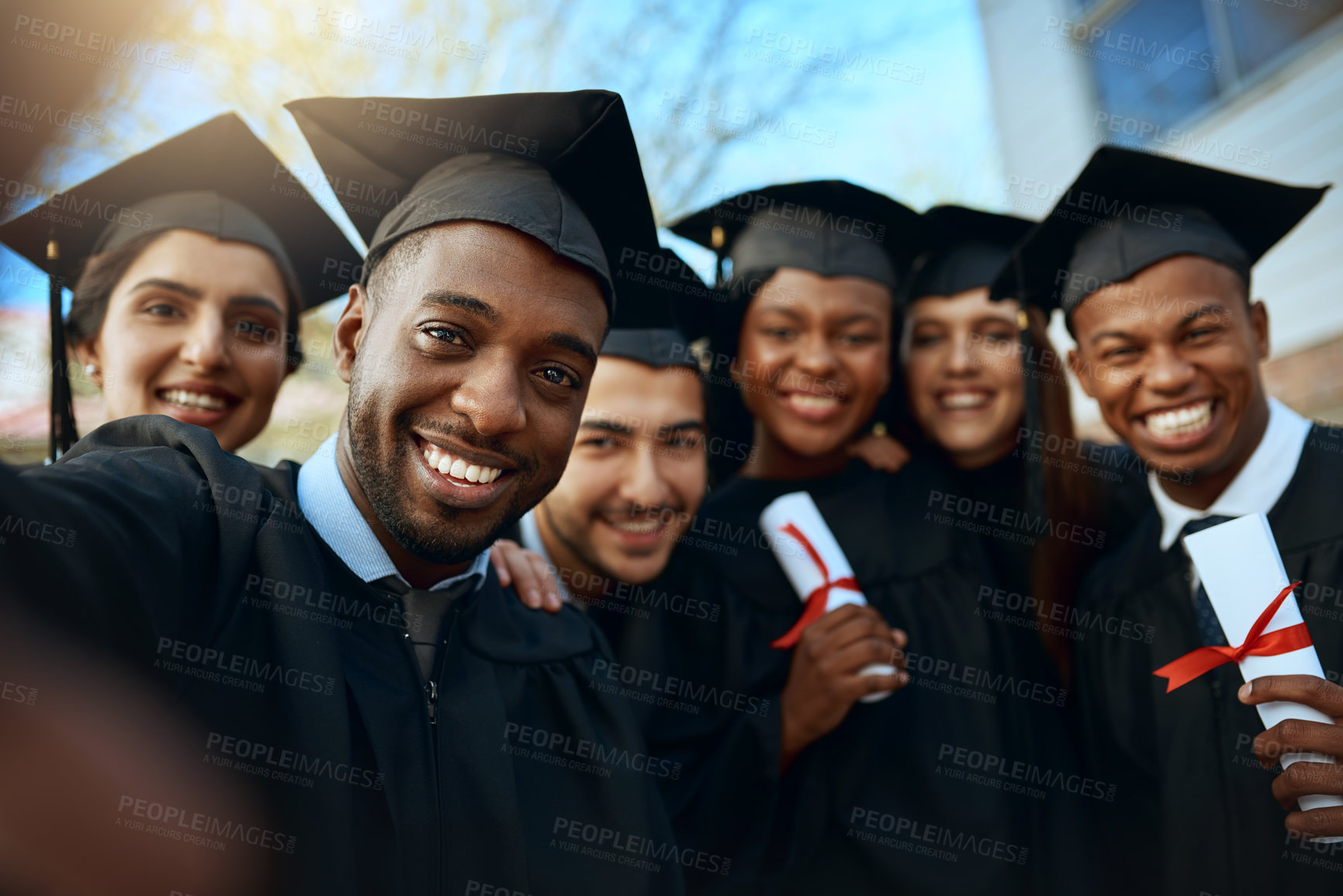 Buy stock photo Portrait of a group of students taking selfies on graduation day