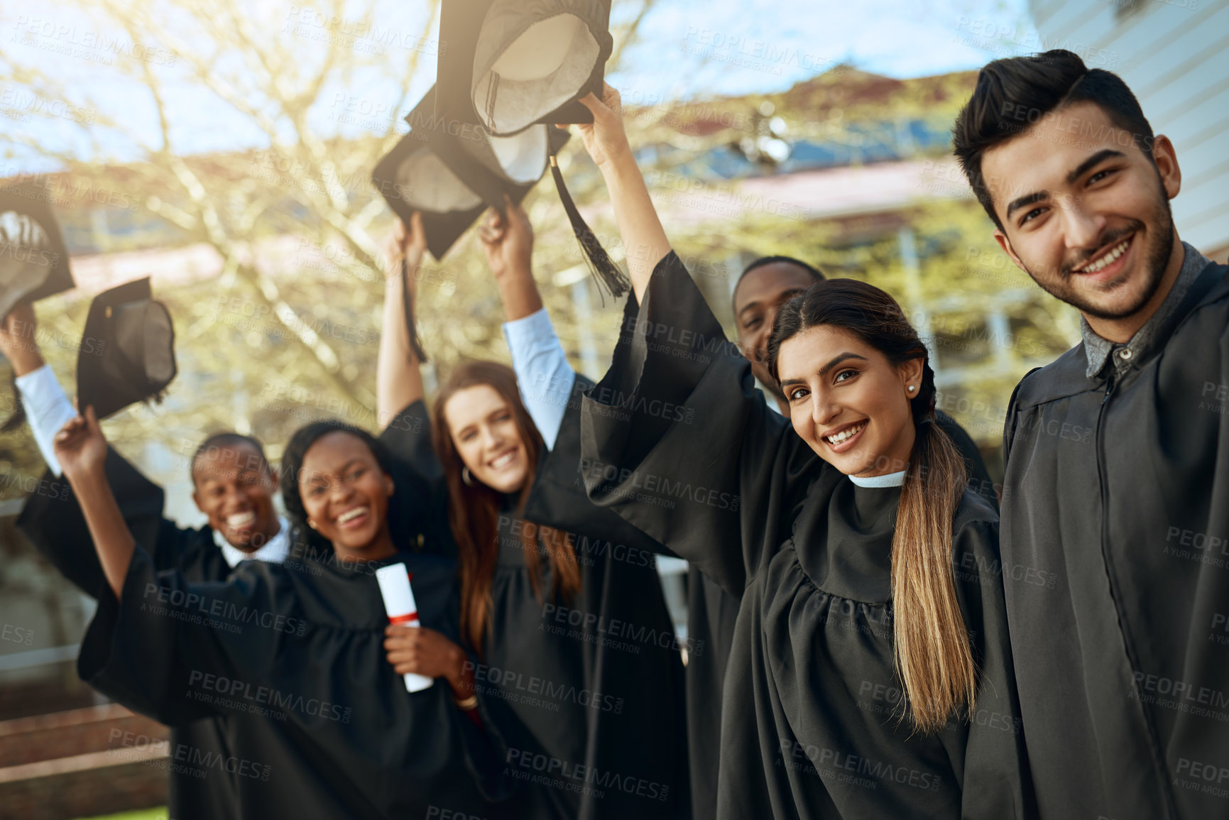 Buy stock photo University, graduation and hats off or group of students together with joy or celebrating academic achievement and outdoors. Certification, victory and happy scholars outside or diversity and robes 