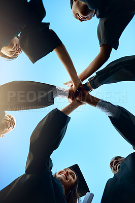 Buy stock photo Hands together, high five and students in huddle at graduation with support or achievement at college. University success, sky or happy graduates in group with people for education goals in low angle