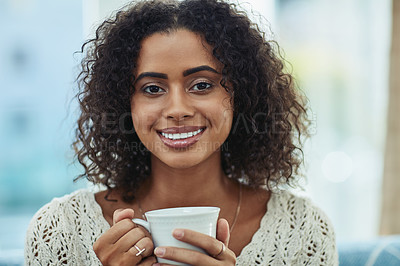 Buy stock photo Shot of an attractive young woman enjoying a cup of coffee at home