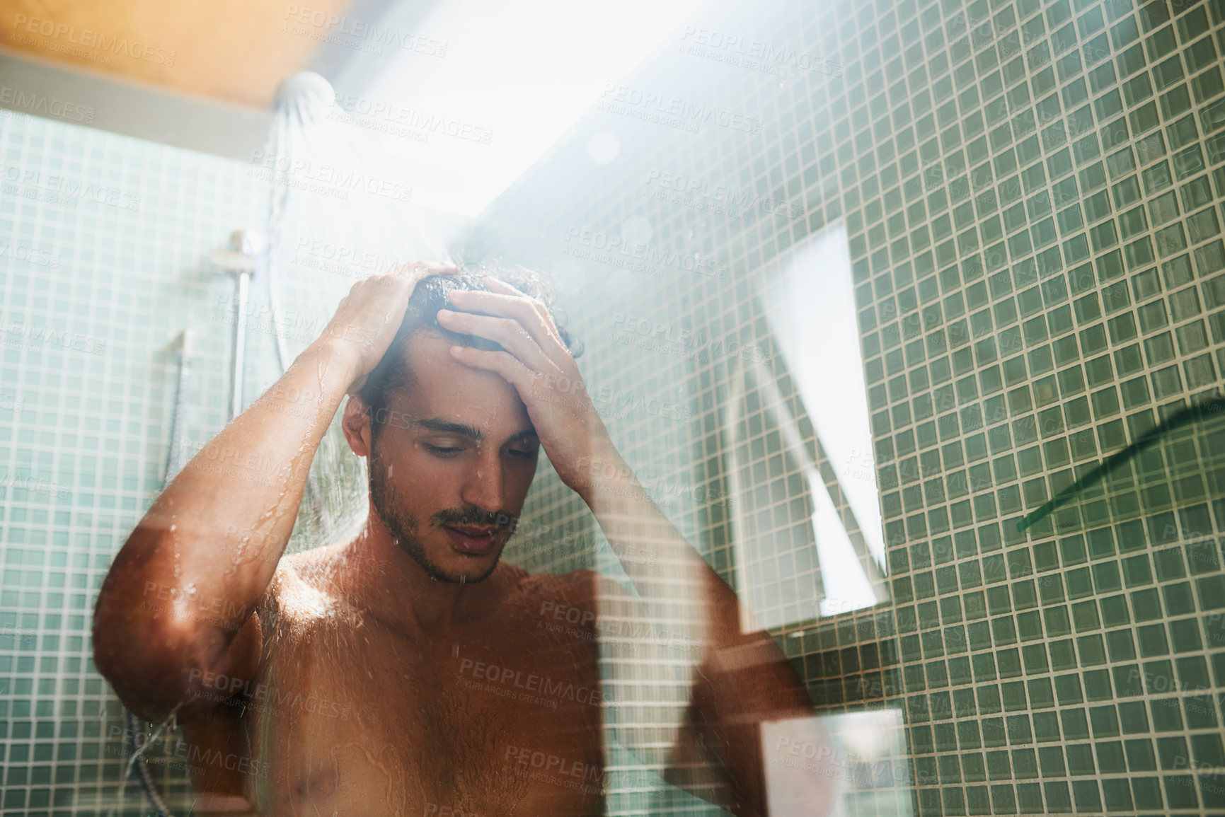Buy stock photo Cropped shot of a handsome young man having a refreshing shower at home
