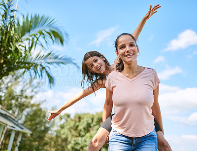 Buy stock photo Portrait of a happy mother and daughter enjoying a piggyback ride in their backyard