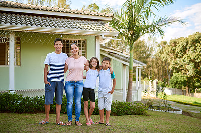 Buy stock photo Portrait of a happy young woman standing together with her daughter and sons in their backyard